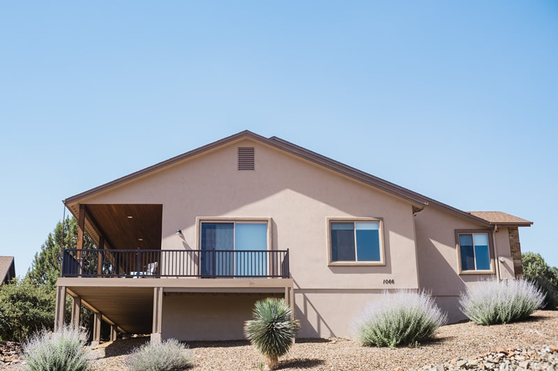 Freshly painted stucco home in Prescott with monsoon clouds clearing